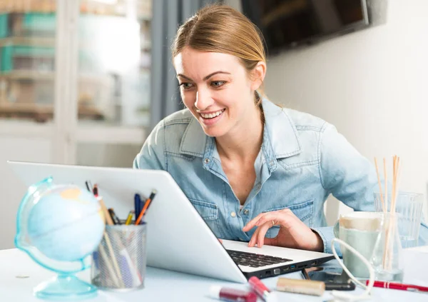 Leende flicka sitter vid bordet hemma beräkna inhemska finanser och räkningar — Stockfoto