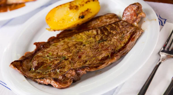 Beef steak with potatoes on a white plate — Stock Photo, Image