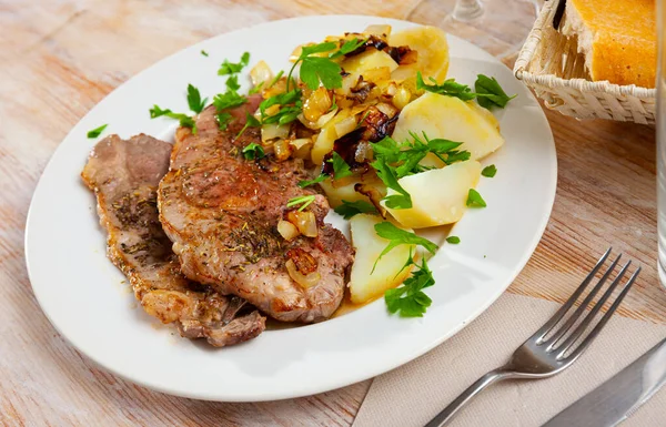 Steaks of pork loin with homestyle boiled potatoes Stock Photo