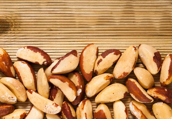 Tasty brazil nuts closeup on wooden surface — Stock Photo, Image