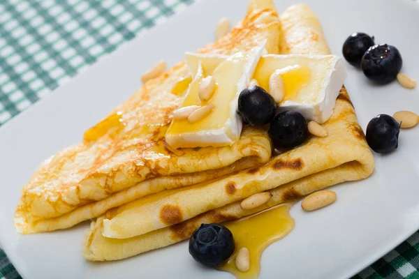 Appetizing pancakes with cheese, honey and nuts — Stock Photo, Image