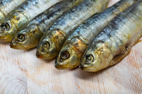 Salted and pressed sardines on wooden table — Stock Photo, Image
