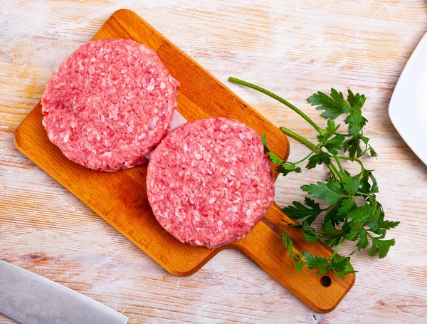 Cooking ingredients, raw burger cutlets — Stock Photo, Image