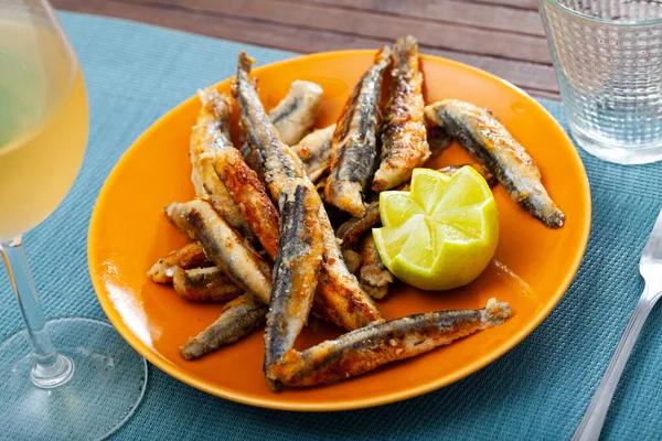 Fried anchovies served with slice of lemon — Stock Photo, Image