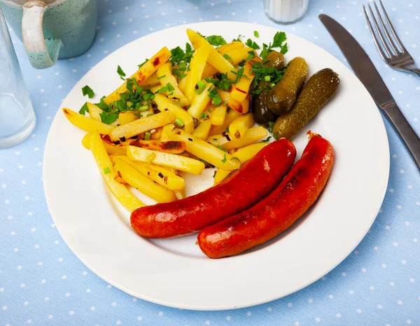 Roasted sausages with fried potatoes and pickled cucumbers