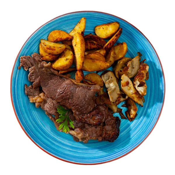 Delicious beef steak with baked potatoes and artichokes — Stock Photo, Image