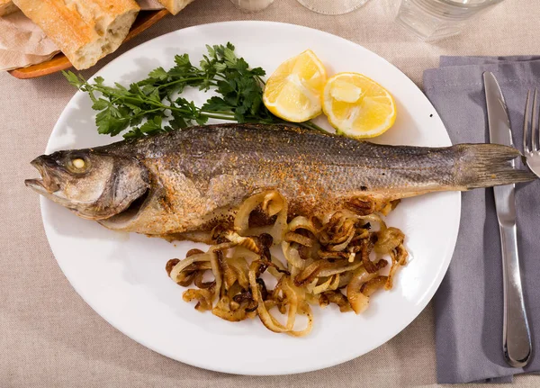 Baked sea bass with fried onion — Stock Photo, Image