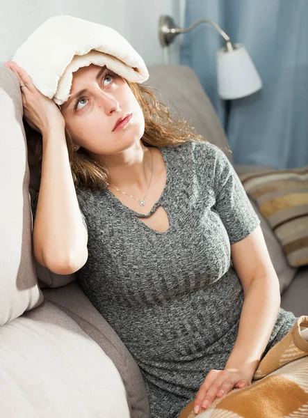 Female holding compress on her head — Stock Photo, Image