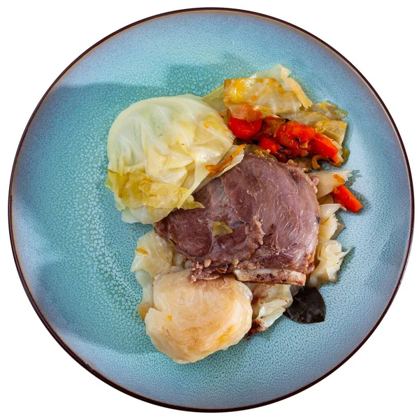 Image of baked pork cheeks with cabbage and carrot at plate