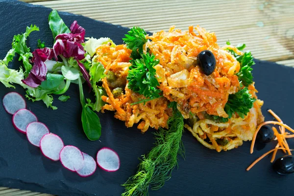 Tasty fried carrots cutlets with greens served at plate on table — Stock Photo, Image