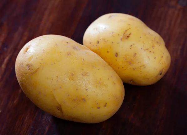 Duas batatas no fundo de madeira — Fotografia de Stock