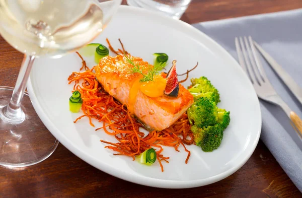 Salmon steak on carrot brush — Stock Photo, Image