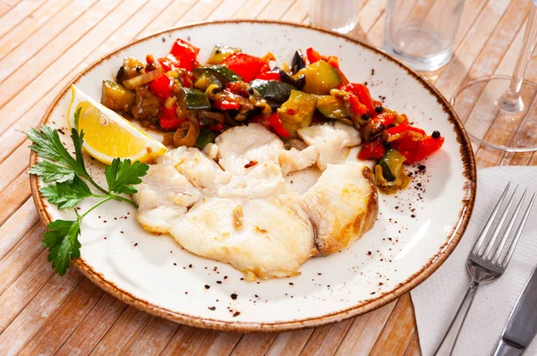 Prepared blue shark served with fried vegetables on plate on wooden table — Stock Photo, Image