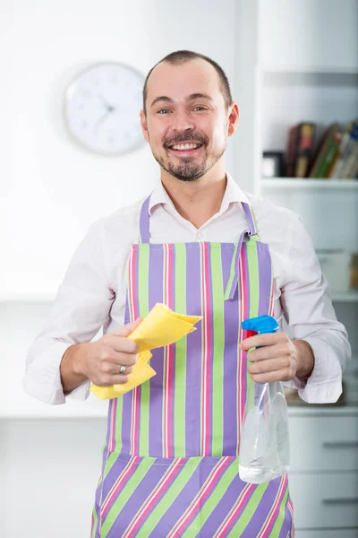 Young man in apron cleaning table — Stock Photo, Image