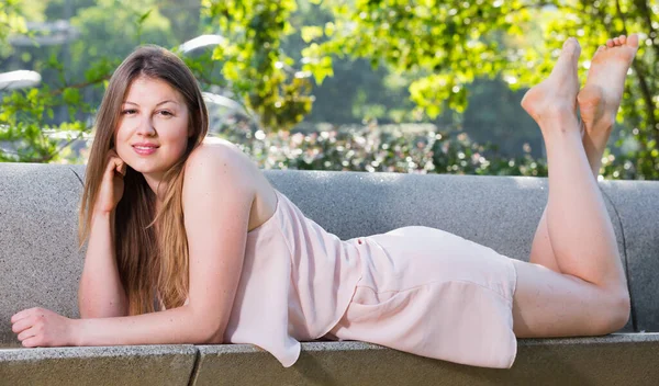 Girl is lying on bench in her free time — Stock Photo, Image