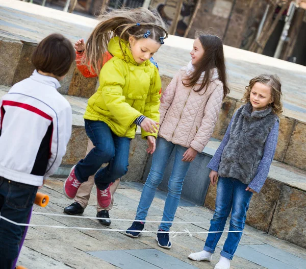 Children playing rubber band jumping Stock Photo