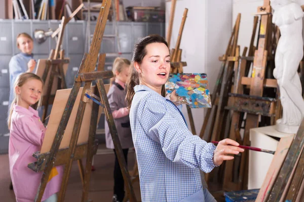 Teacher giving master class during painting class Royalty Free Stock Images