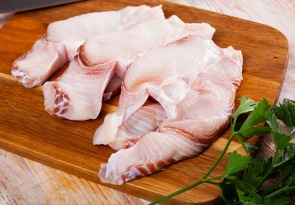 Blue shark raw steaks with greens on wooden background — Stock Photo, Image