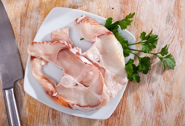 Raw blue shark steaks on wooden table with fresh parsley — Stock Photo, Image