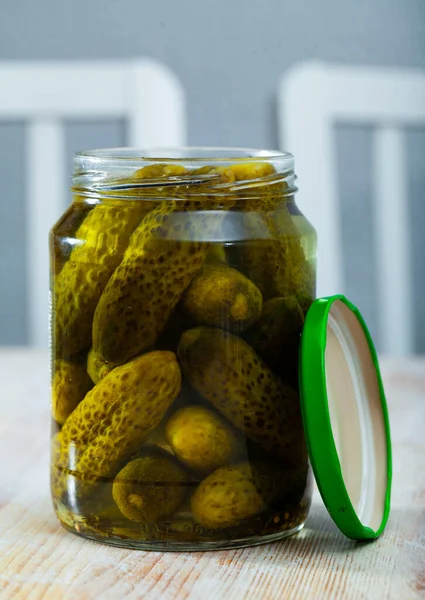 Pickled cucumbers with spices in glass jar — Stock Photo, Image