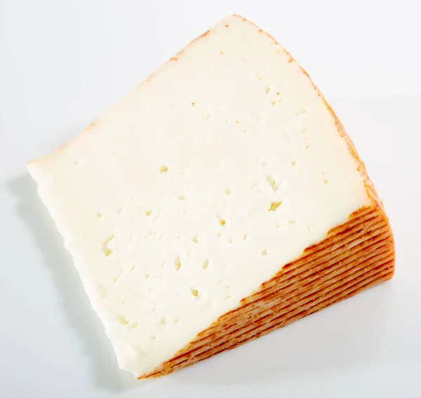 Piece of fresh semi-soft cheese — Stock Photo, Image