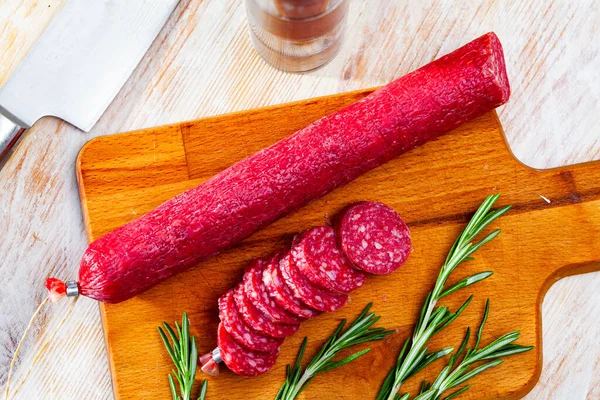 Dried sausage on cutting board. — Stock Photo, Image