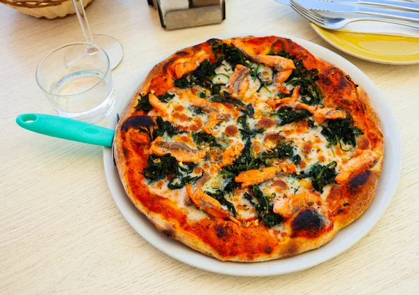 Cheese based pizza with fresh salmon and spinach — Stock Photo, Image