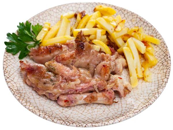 Close up of grilled pigs trotter with fried potato and asparagus served on white plate on wooden table — Stock Photo, Image