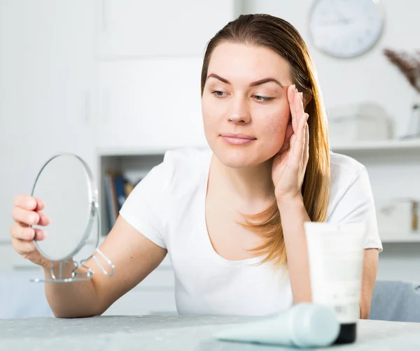 Young woman is satisfied of quality her skin in with mirror — Stock Photo, Image