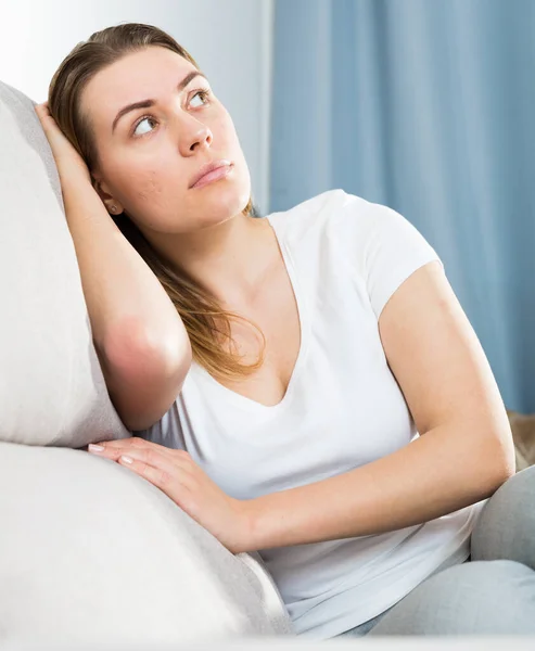 Sad woman is propped her cheeks with hands because she bored — Stock Photo, Image