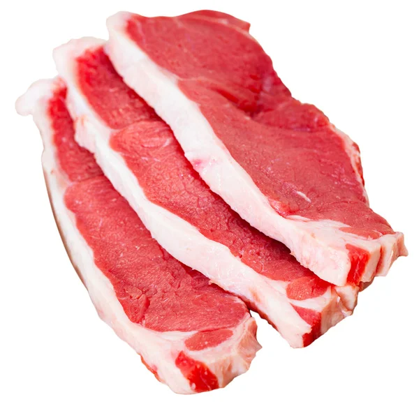 Pieces of beef with peas of bitter pepper on cutting board — Stock Photo, Image