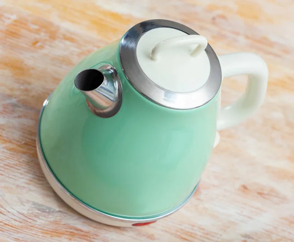 Turquoise electric tea kettle on wooden table — Stock Photo, Image