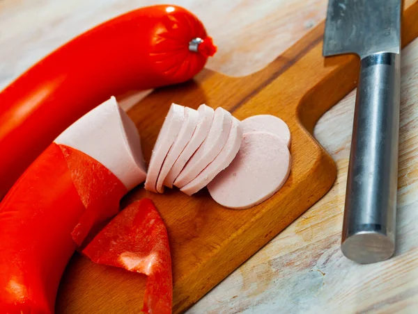 Appetizing boiled sausage mortadella on wooden table — Stock Photo, Image