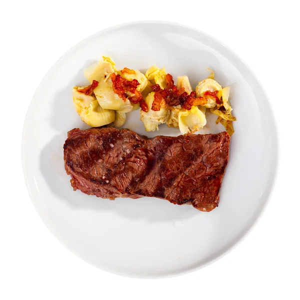 Delicious veal steak with fried artichokes on blue plate — Stock Photo, Image