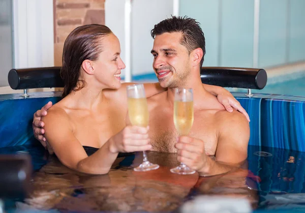 Couple is drinking champagne while resting — Stock Photo, Image