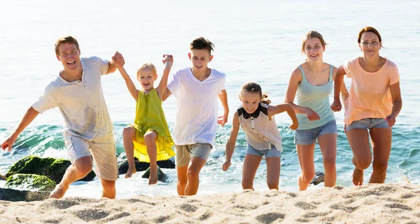 Big family running on beach — Stock Photo, Image