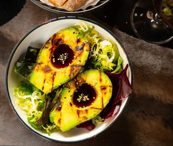 Grilled avocado with ponzu sauce and greens
