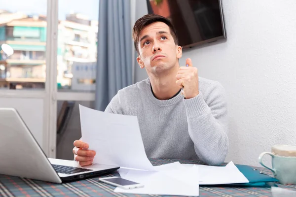 Trött man arbetar med bärbar dator i hemmet — Stockfoto