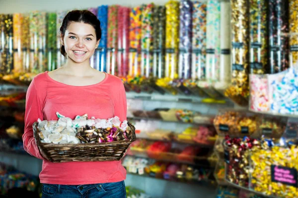 Girl in the shop with lots of sweets — Stock Photo, Image