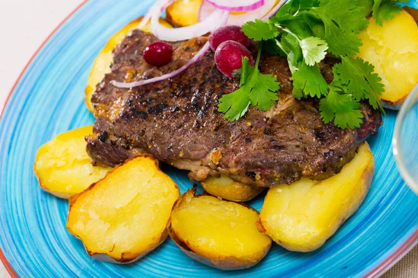 Prepared beef steak with fried potatoes and greens served — Stock Photo, Image