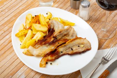 Roasted pork streaky bacon with baked potatoes clipart