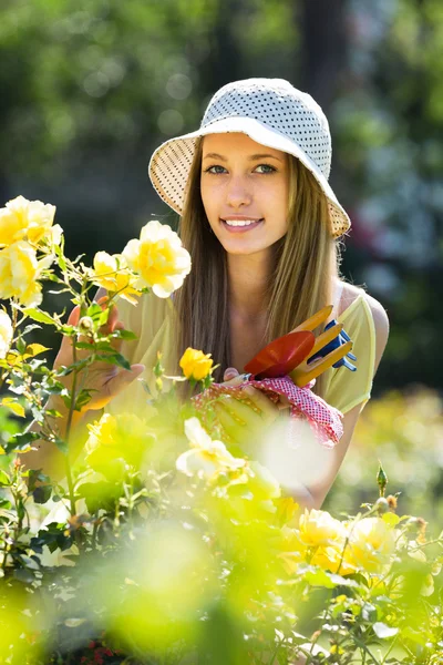 Girl with garden tools — Stock Photo, Image