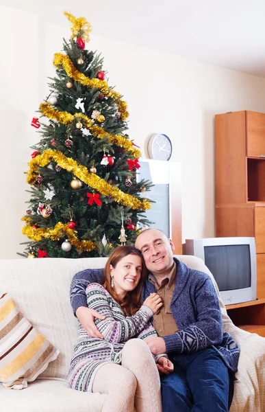 Loving couple near Christmas tree — Stock Photo, Image