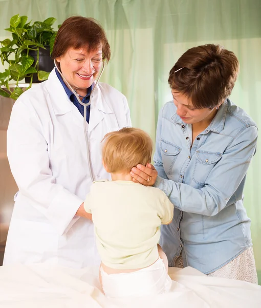 Médico pediatra feliz examinando niño pequeño — Foto de Stock