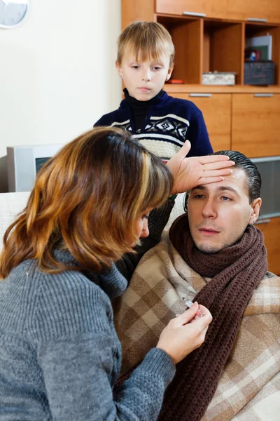 Homem doente cercado por esposa e filho carinhosos — Fotografia de Stock