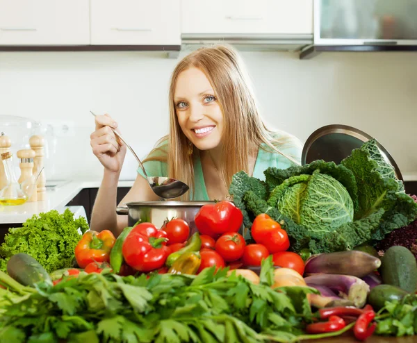 Femme cuisine avec tas de légumes — Photo