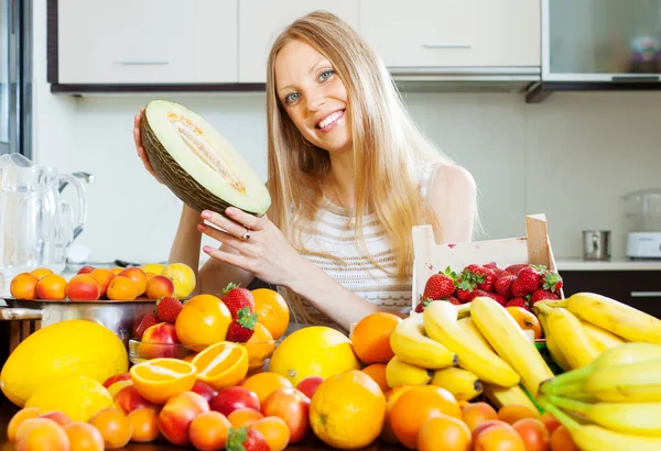 Happy blonde young woman holding melon — Stock Photo, Image