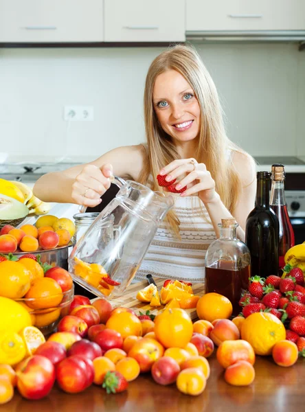 Happy girl making fruits beverages with alcohol — Stock Photo, Image