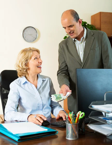 Happy female secretary receiving from boss salary — Stock Photo, Image