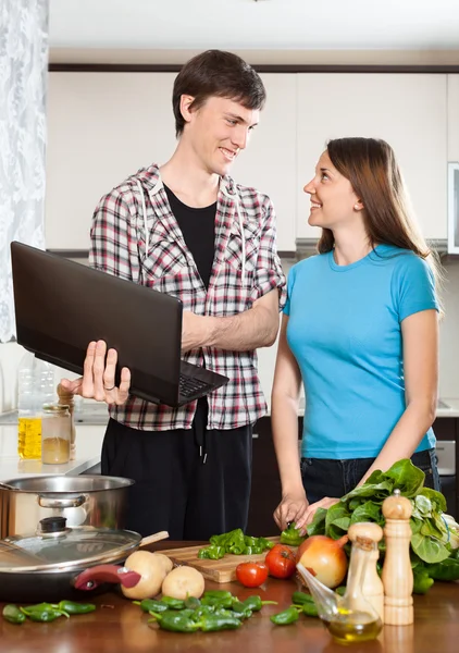 Smiling man shows the new recipe to girl — Stock Photo, Image
